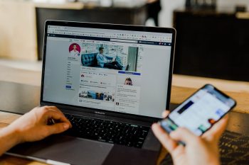 A man looking at his Facebook profile.