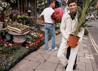 A Ted Maker model carrying a plant.